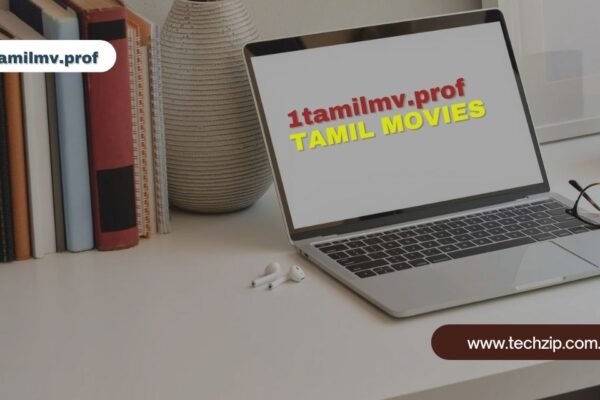 Laptop displaying 1tamilmv.prof website for Tamil movies on a desk next to books